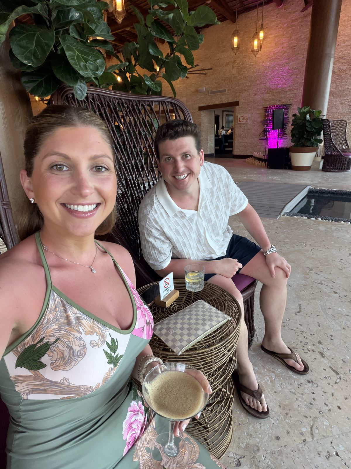 Resort selfie in wicker chairs, espresso martini in hand