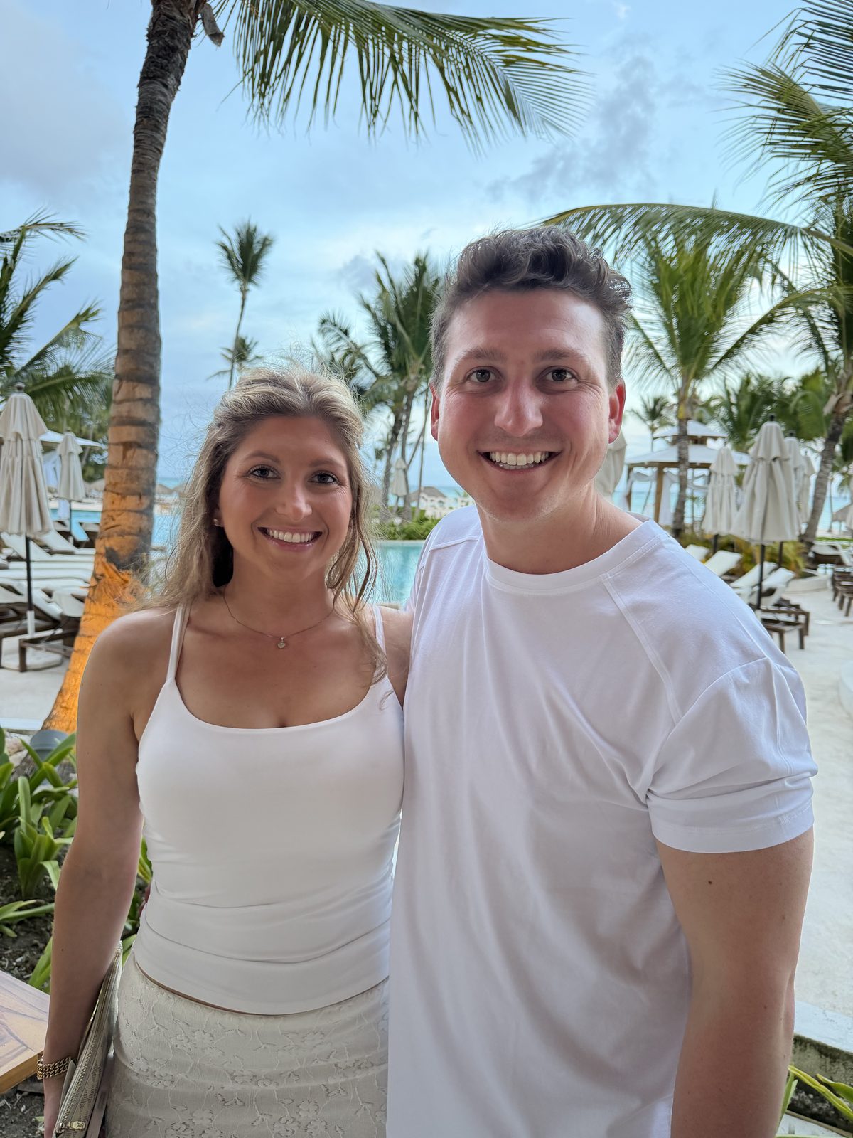 Dressed in white at a tropical resort lounge