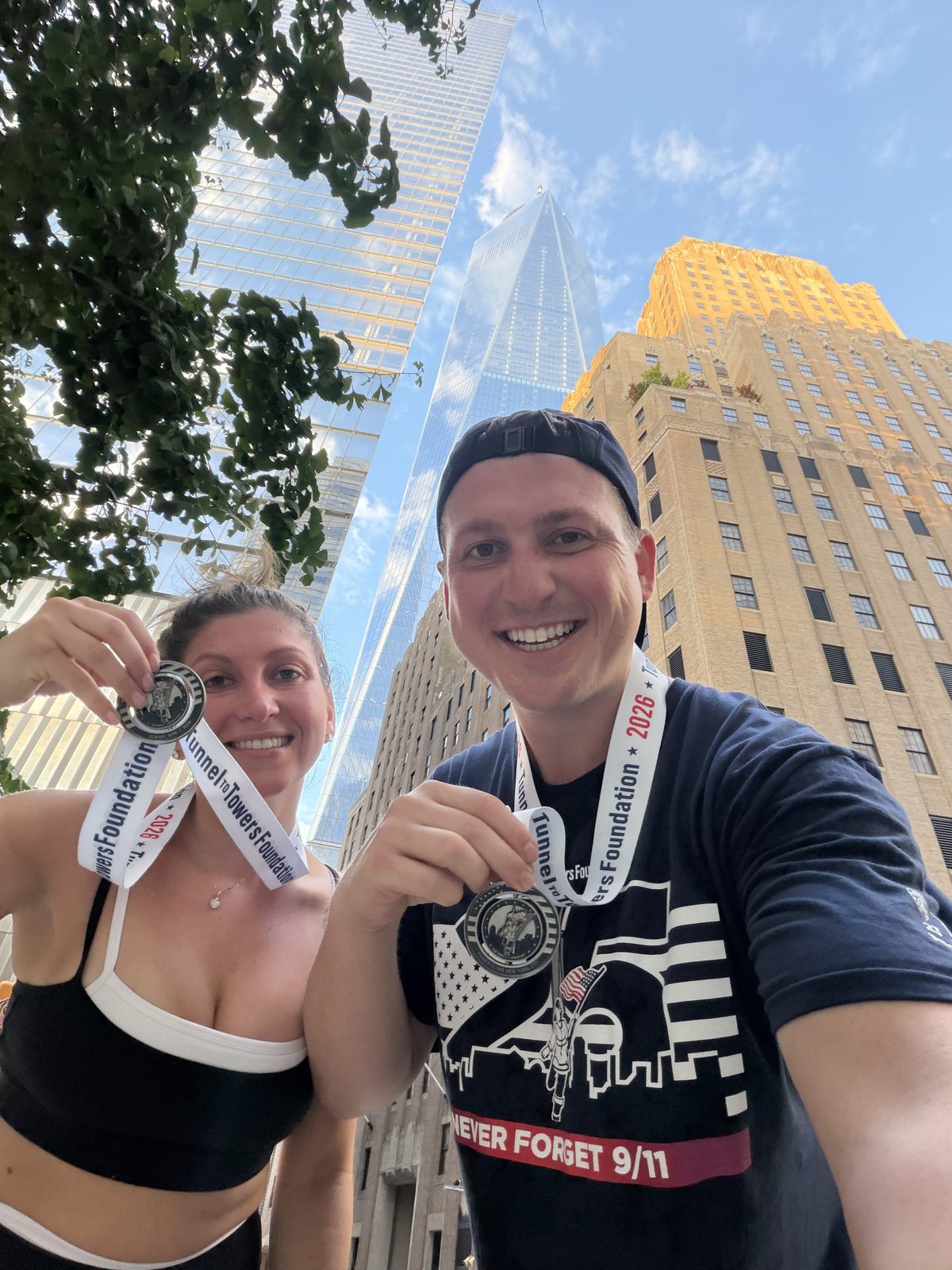 Holding Tunnel to Towers medals in front of One World Trade Center